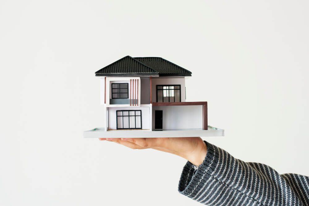 hand-presenting-model-house-home-loan-campaign 