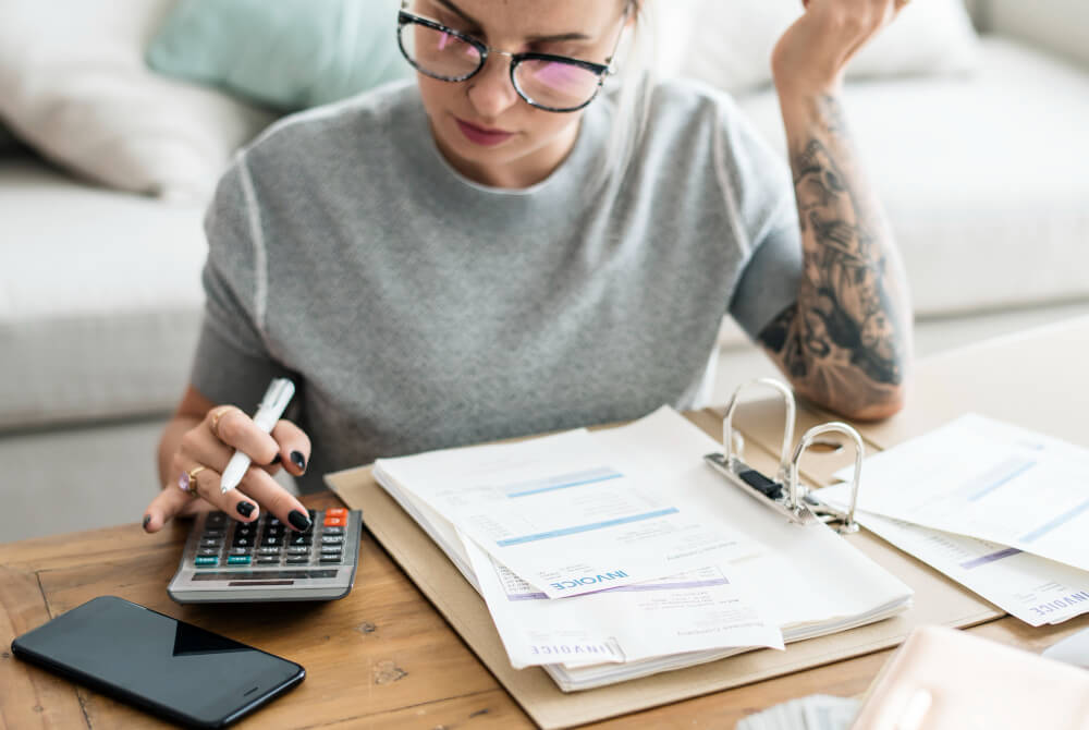 caucasian woman with invoice bills
